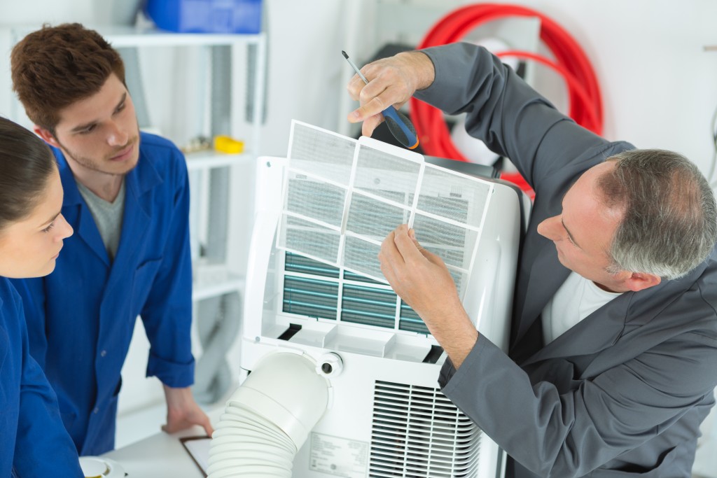 Professionals cleaning the aircon