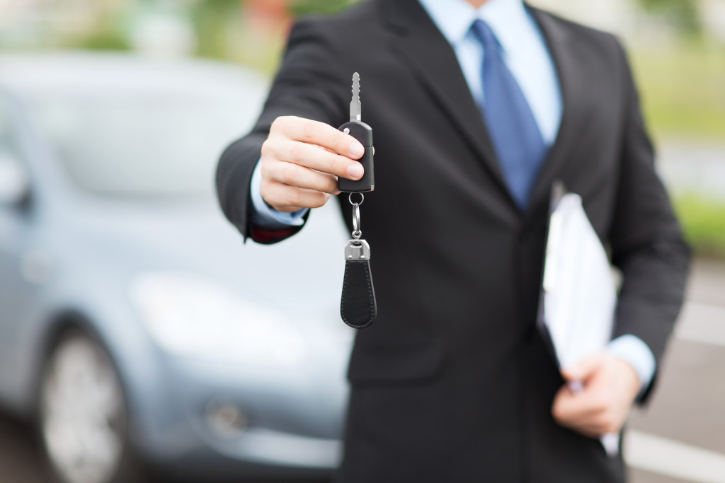 car agent handing car key